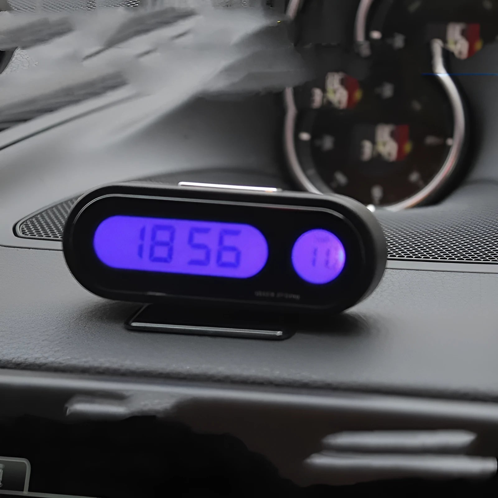Black electronic car clock and thermometer with LED digital display on an adjustable dashboard bracket.