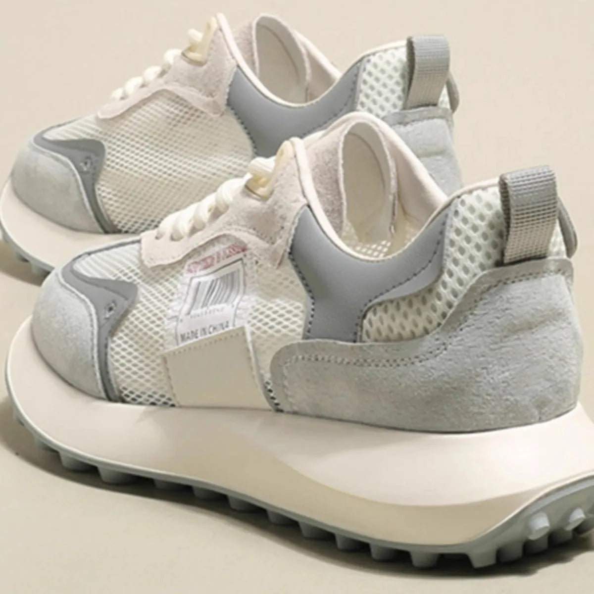 Women's grey and pink retro sneakers with low-top design and rubber soles