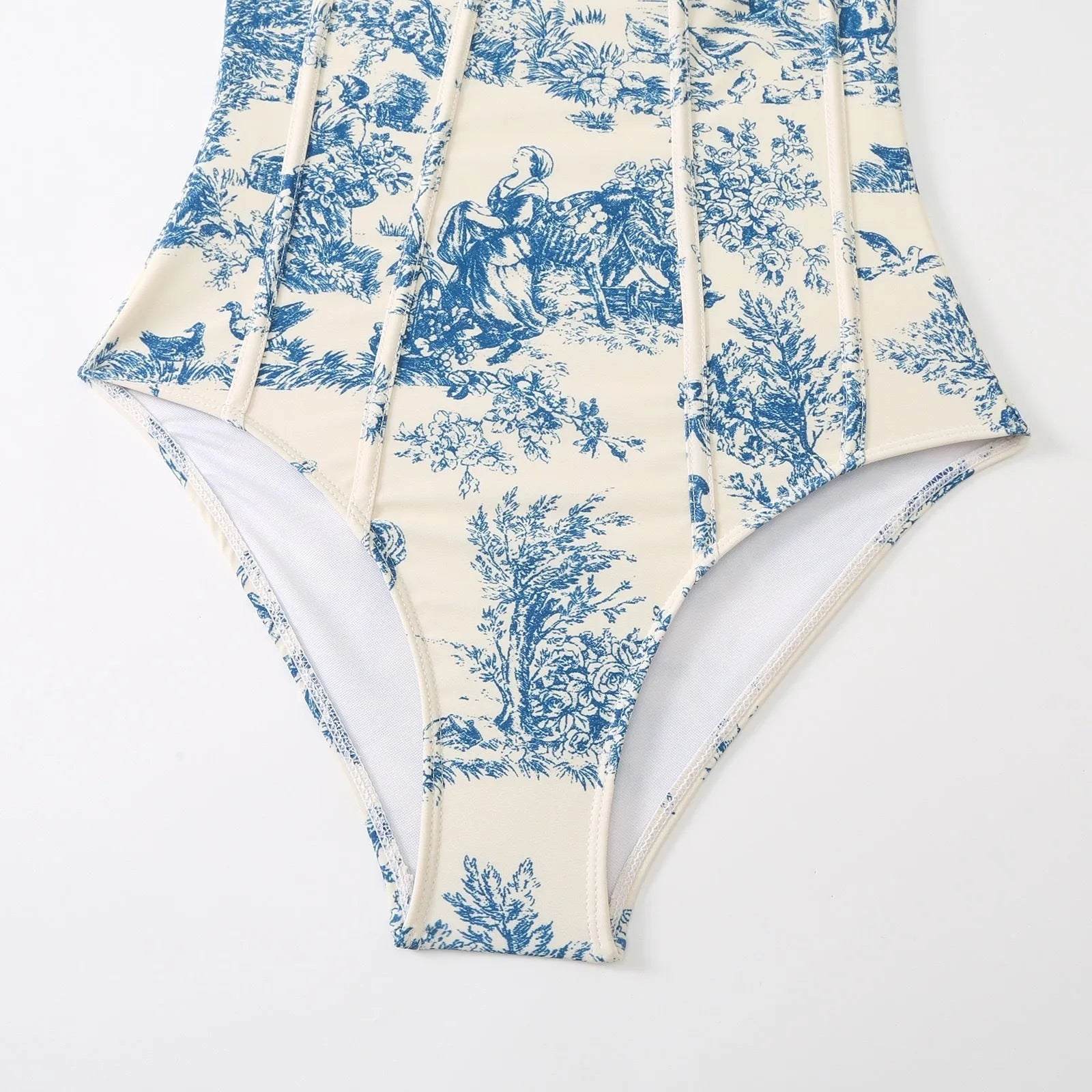 Blue women's one-piece swimsuit with a matching separate gauze skirt on a hanger.