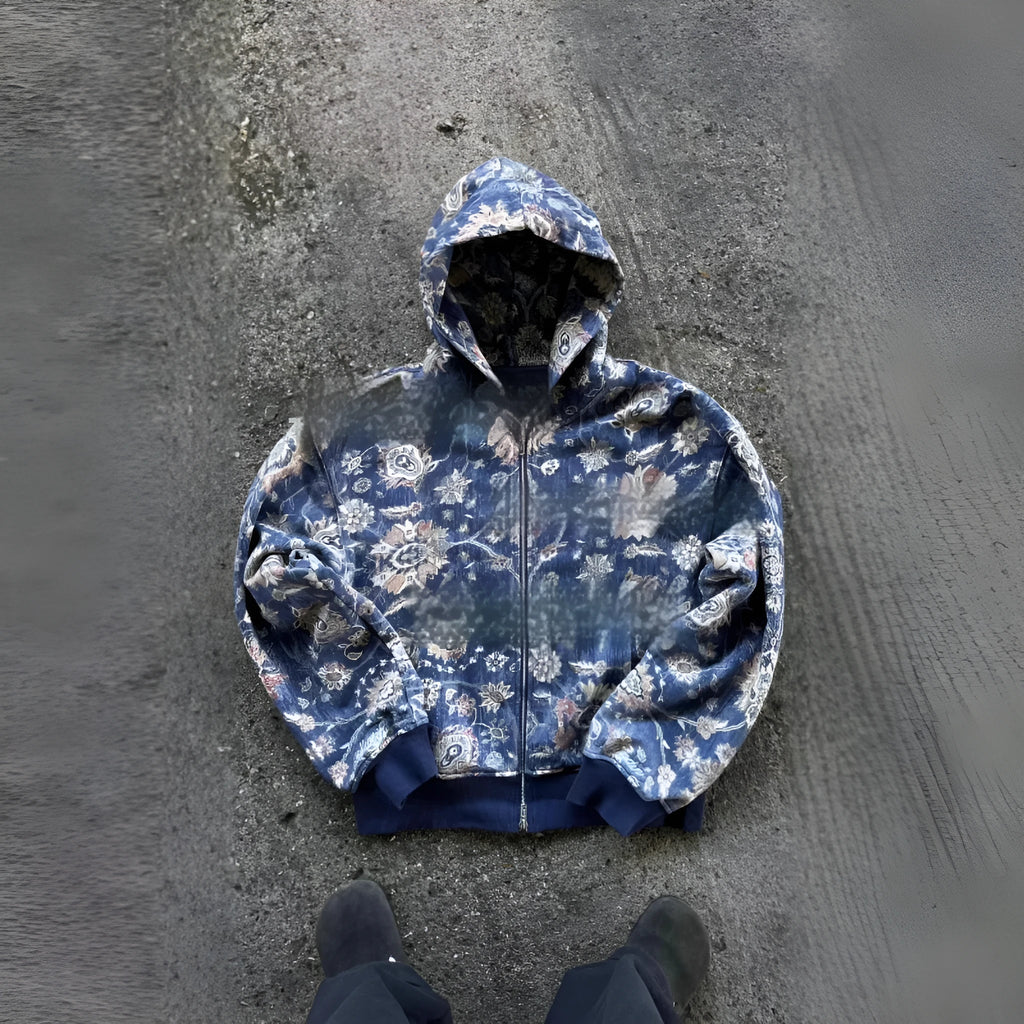 A red loose-fit men's hooded zip coat with long sleeves on a hanger.
