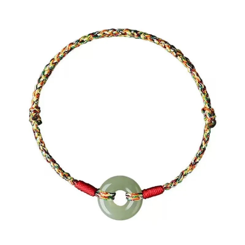 Colourful woven rope bracelet with silver peace buckle closure on wrist