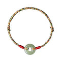 Colourful woven rope bracelet with silver peace buckle closure on wrist