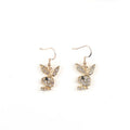 Close-up of a pair of small silver rabbit stud earrings with a sparkling rhinestone set in the centre on a white background.