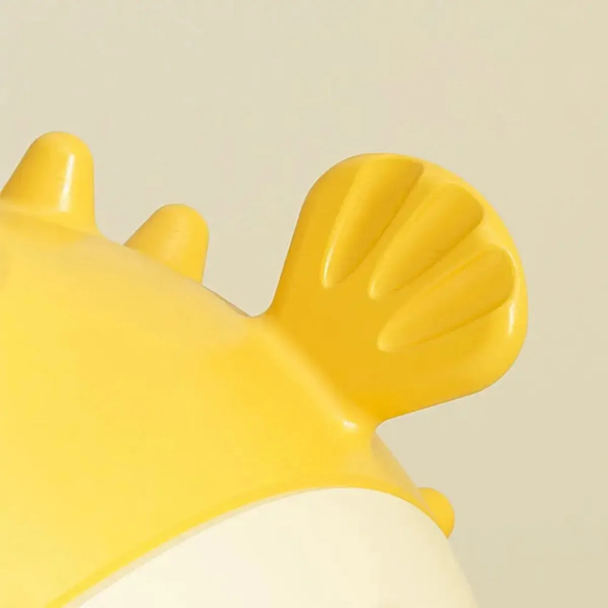 A yellow, fish-shaped durable dog chew toy with a textured surface and built-in squeaker.