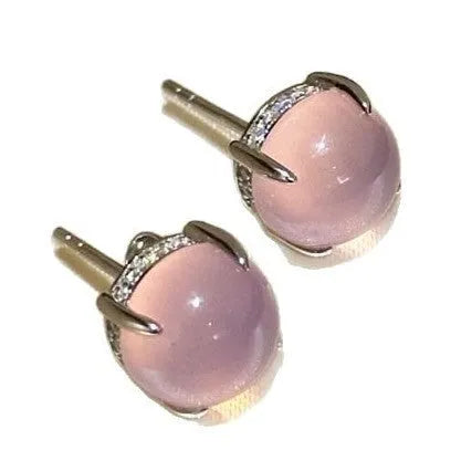 Chalcedony stud earrings with round egg surface design and four-claw settings in copper