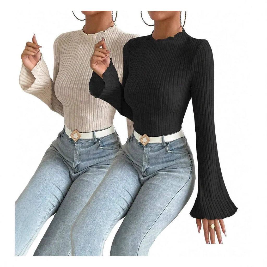 A person wearing a black long sleeve round neck top with a brushed sunken stripe texture and lantern sleeves.