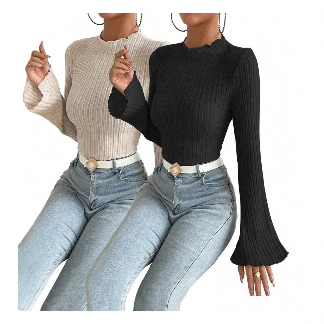 A person wearing a black long sleeve round neck top with a brushed sunken stripe texture and lantern sleeves.