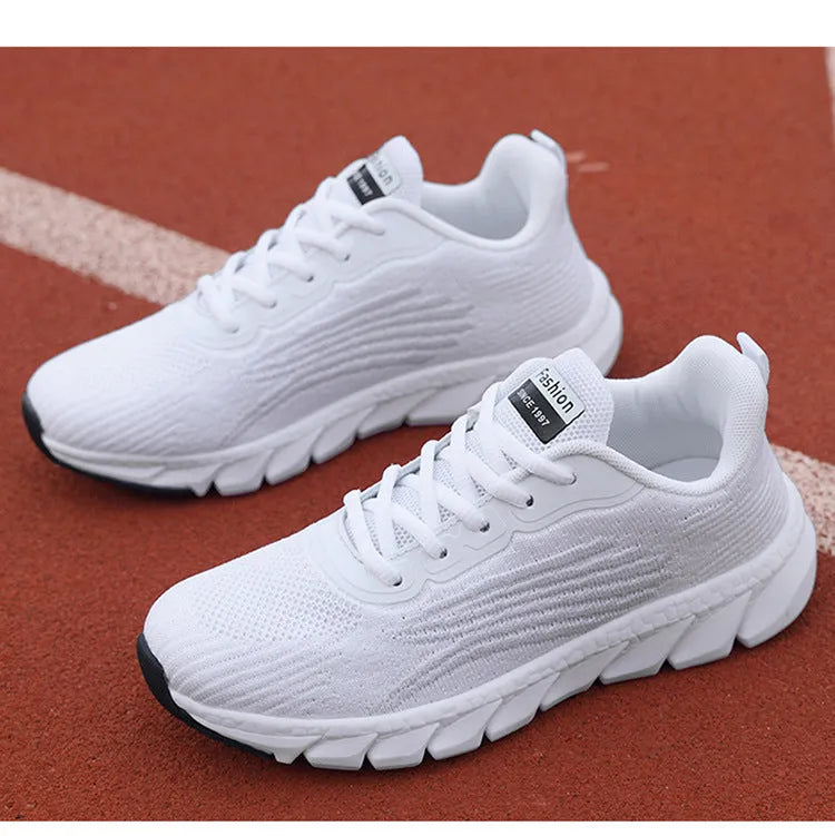 Women's black and white low-top running sneakers with cross strap design and MD soles