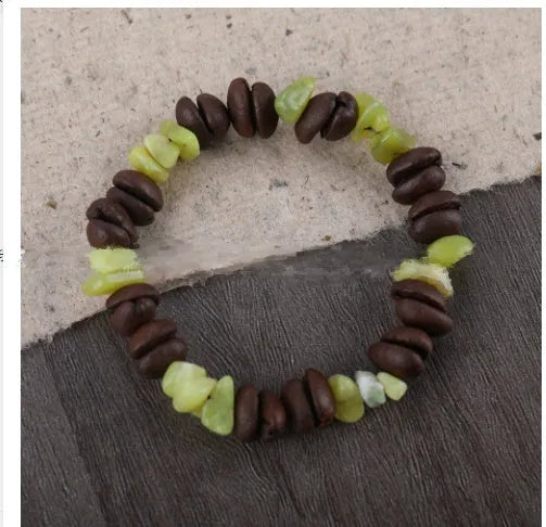 Handmade coffee bean bracelet with 16mm geometric charm showing colour variations