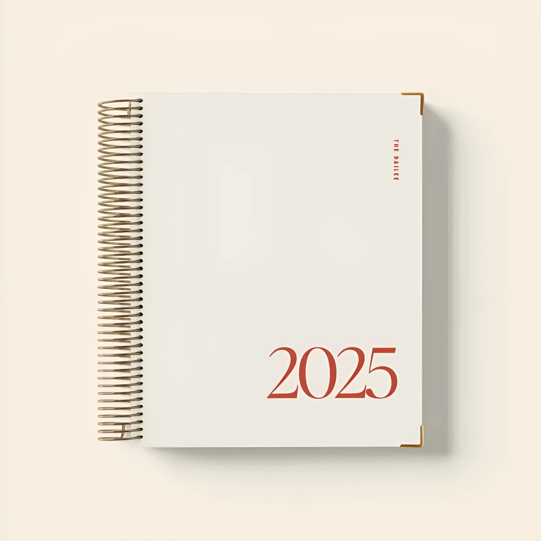Cherry red daily schedule coil notebook with wire-o binding open on desk