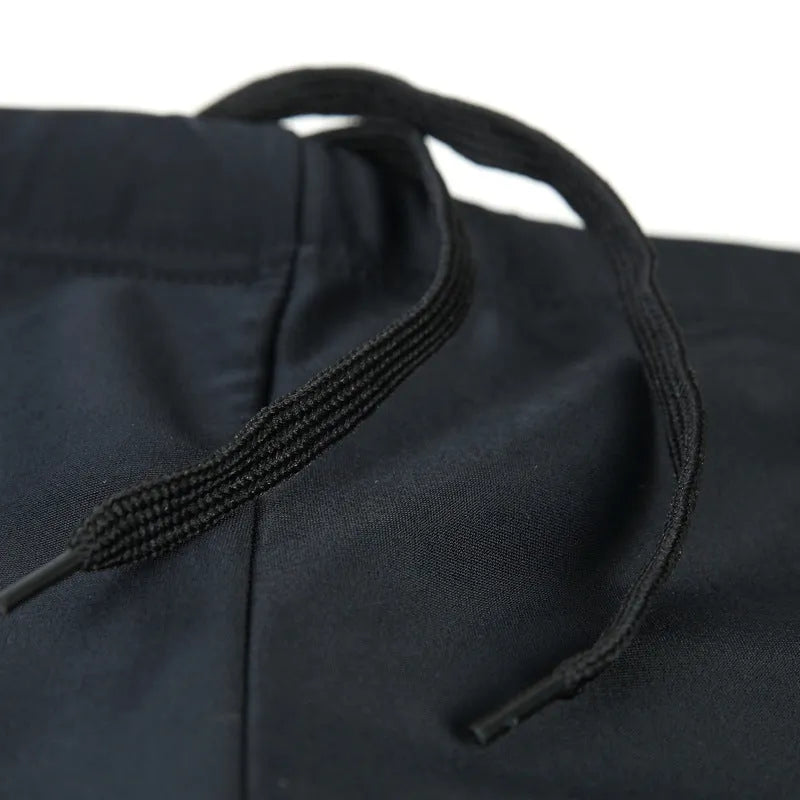 Men's plus size swim trunks with flame pattern and matching swimming cap on a black background.