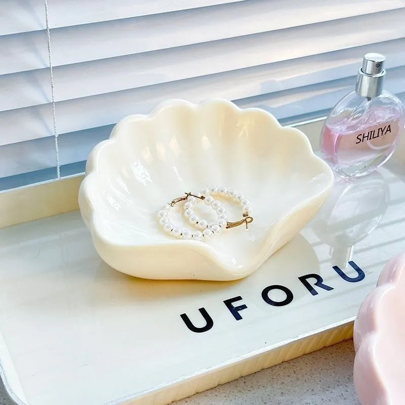 White plastic shell-shaped soap dish for bathroom countertop