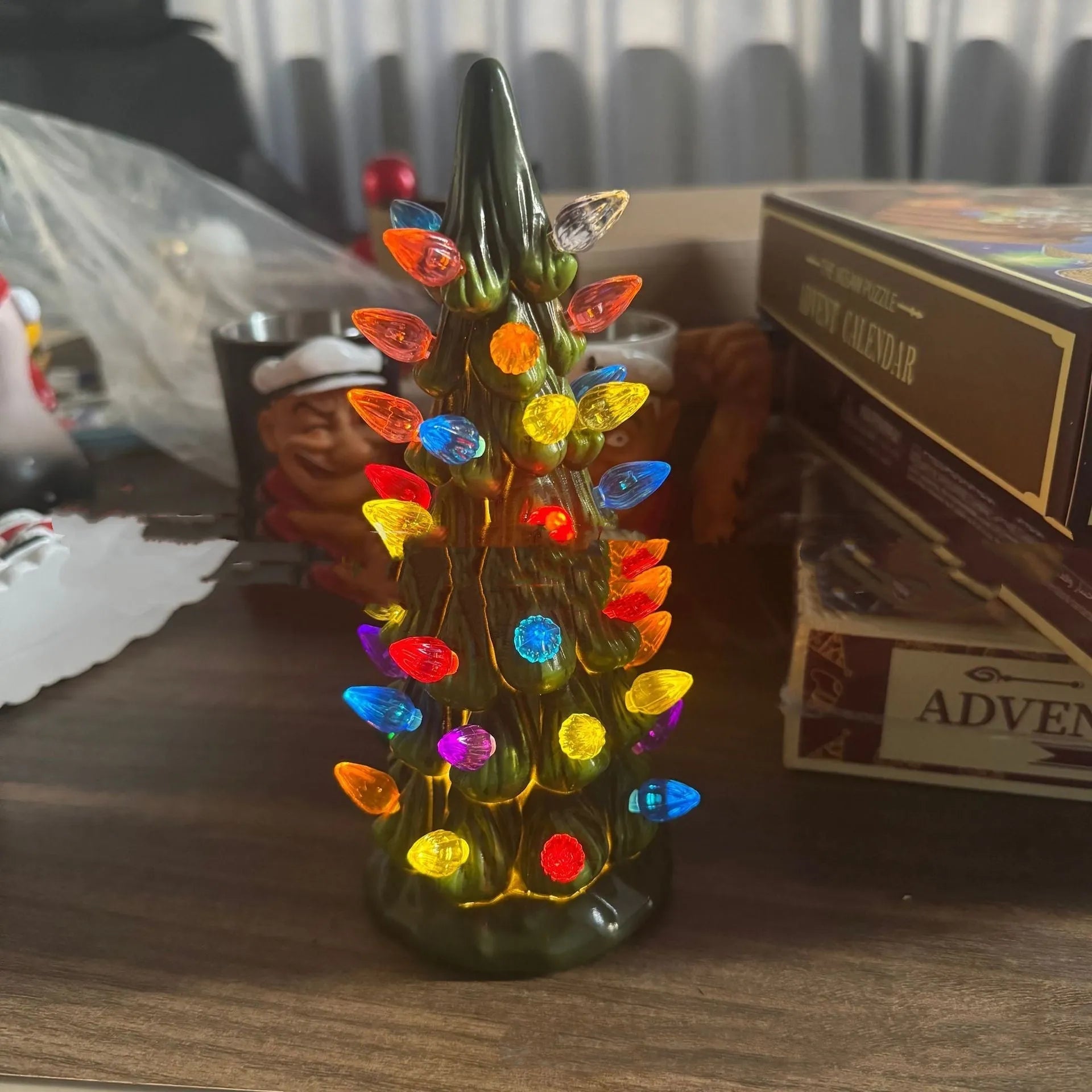 A resin Christmas tree decoration with lights, shown in a European style, suitable for indoor or courtyard use.