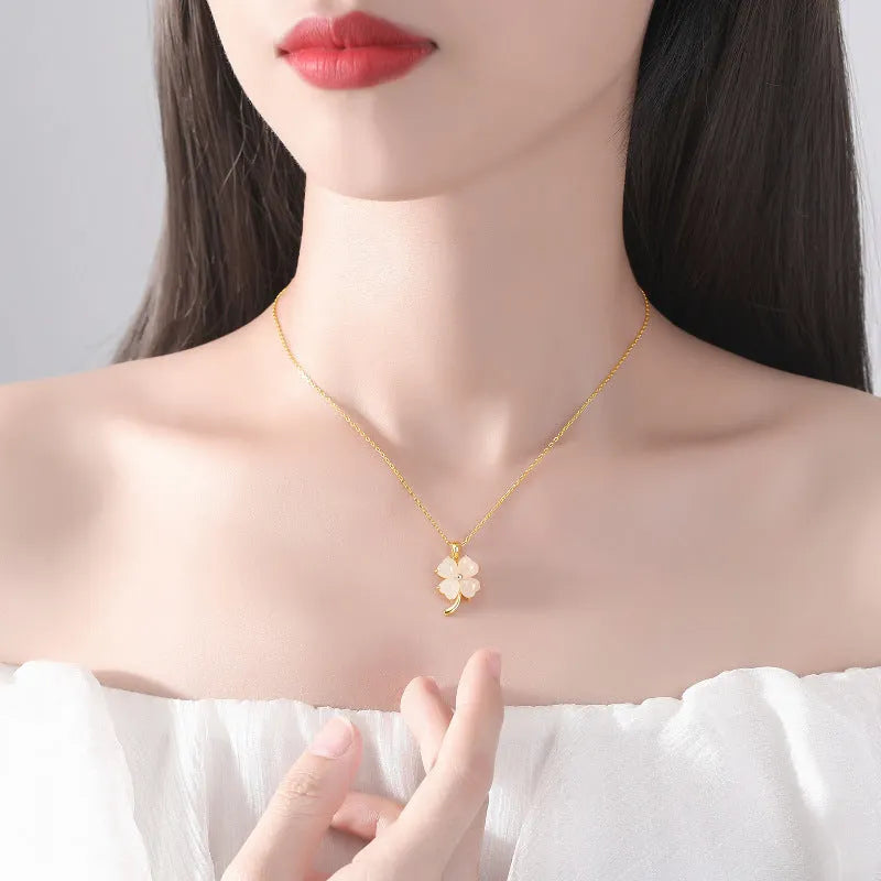 Women's four-leaf clover necklace with Hetian jade pendant on an adjustable sterling silver chain.