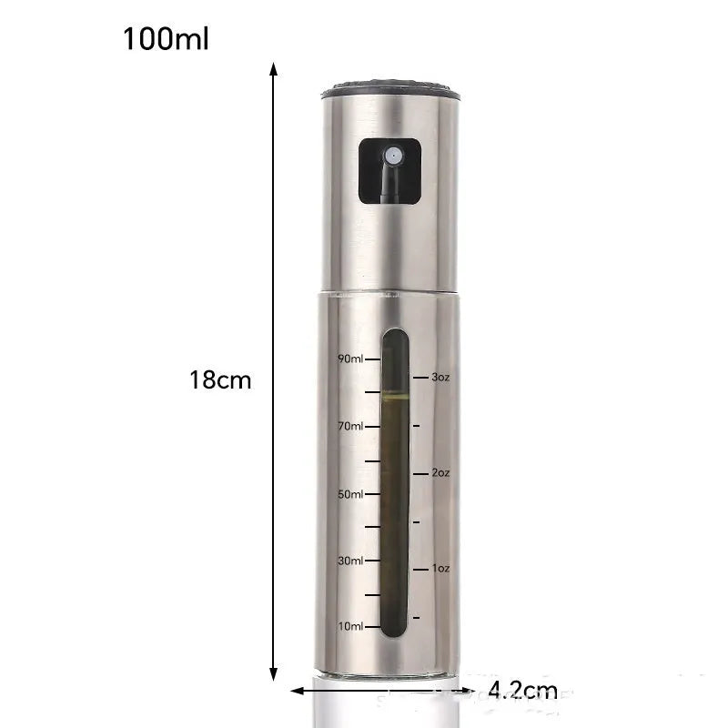 Stainless steel press spray oil injection bottle with glass body and 100ml capacity on kitchen countertop