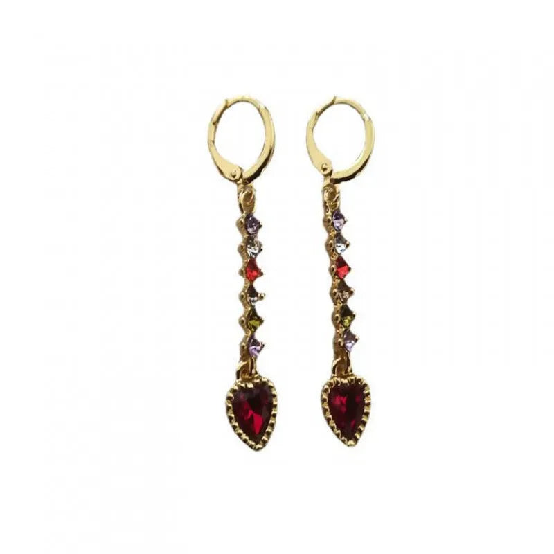 A pair of women's heart-shaped earrings with an electroplated gold or silver finish on an alloy base.
