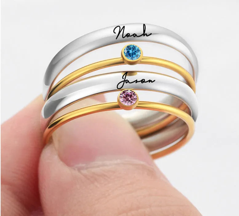 A geometric titanium steel ring with a December birthstone colour, gold electroplated handle, and engraved steel lettering.