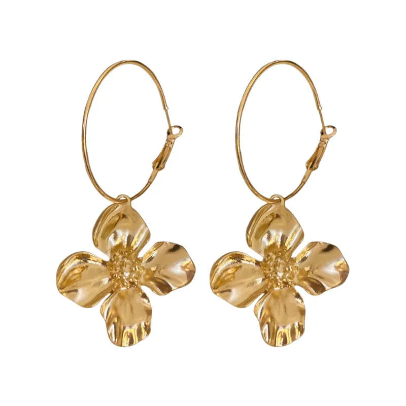 A pair of metal flower geometric earrings with a silver needle post in a gold or silver electroplated finish.