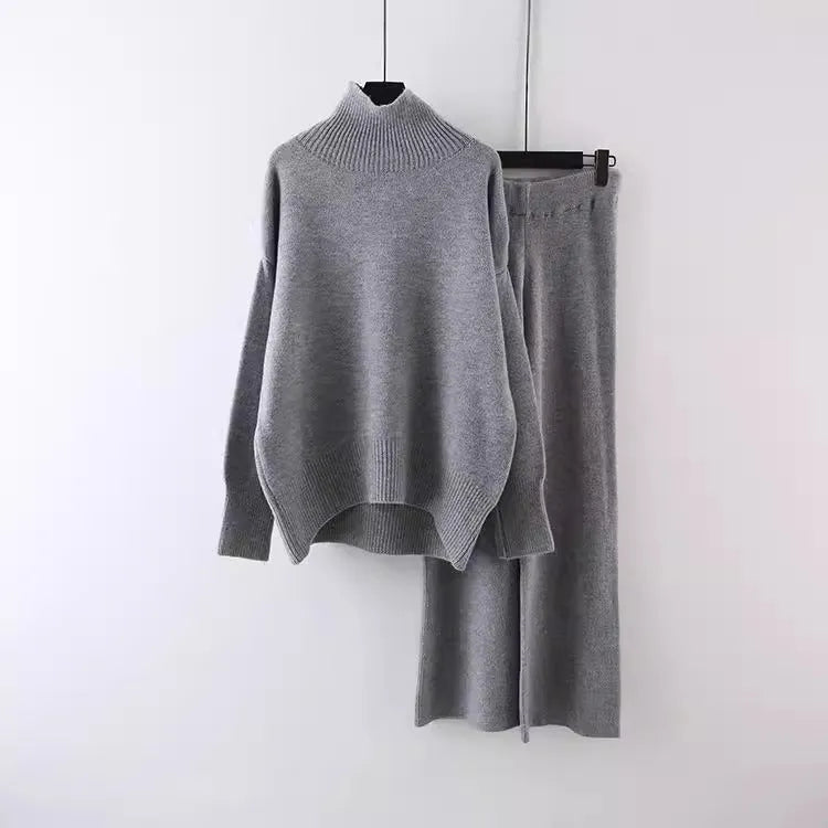Women's milky white acrylic knit two-piece set featuring a long-sleeve sweater and wide-leg trousers on a hanger.