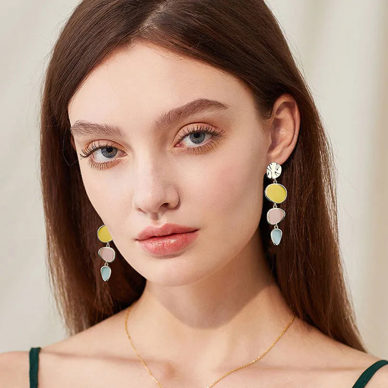 A pair of simple disc-shaped earrings with a blended Morandi colour finish on a sterling silver post.