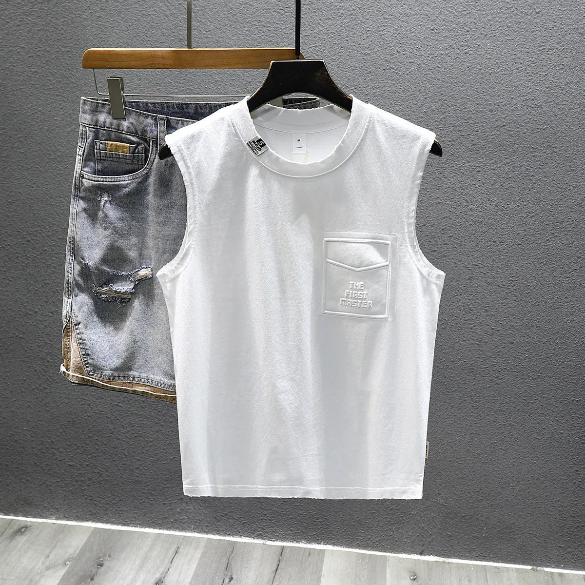 Men's solid colour loose fit cotton sleeveless t-shirt on hanger, black and white options.