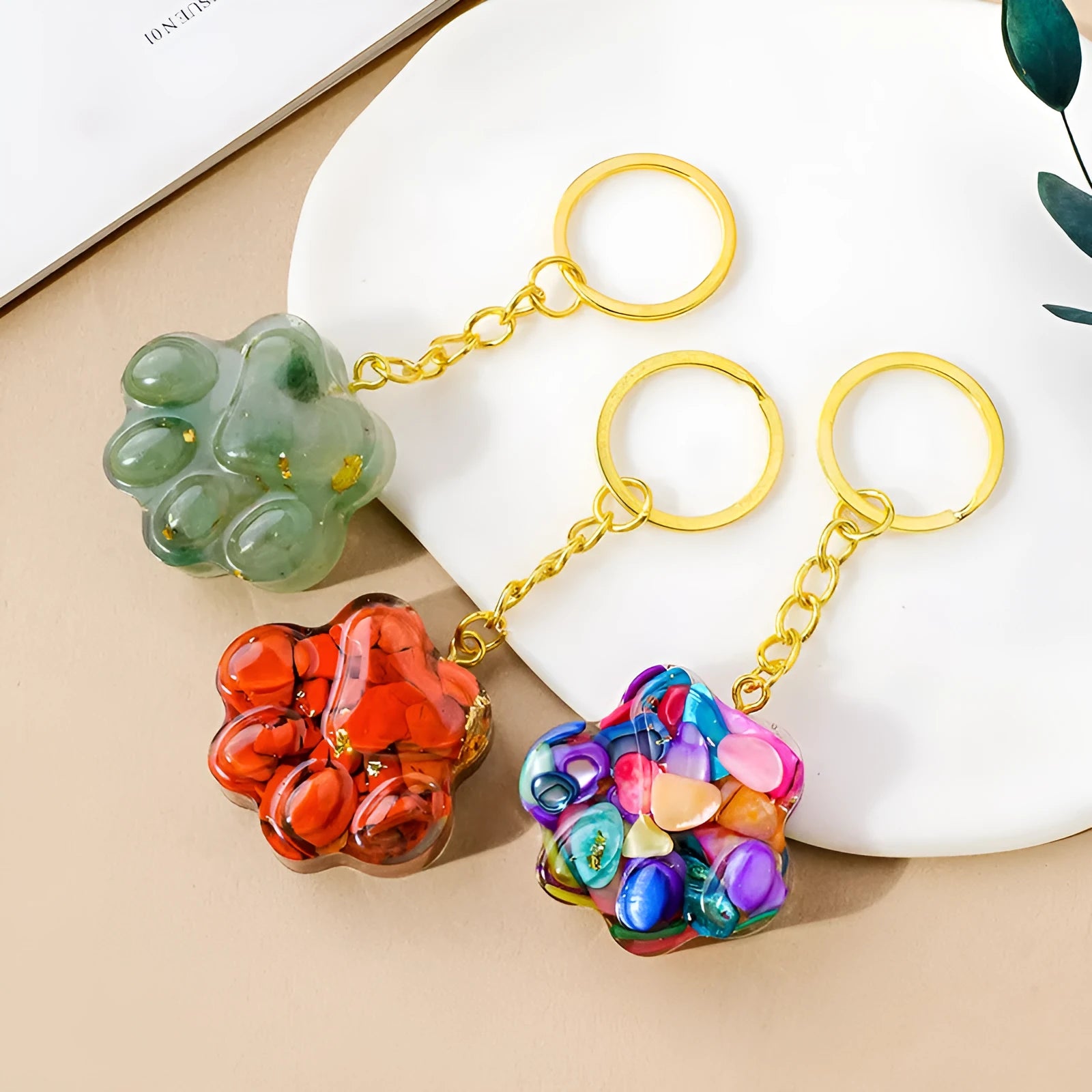 Natural crystal cat's paw keychain pendant in pink crystal, showing detailed 3D carving and metal keyring.