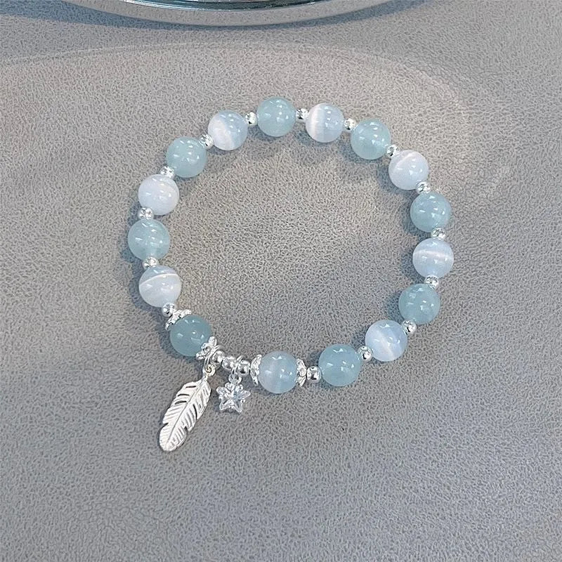 Small white crystal bracelet with blue moonlight colour and star design, Korean-style glass jewellery.