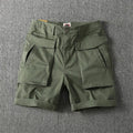 Men's beige cargo shorts with multiple pockets on a plain background, showing straight-leg fit and button closure.