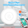 Compact white Zigbee wireless water flood sensor on a table