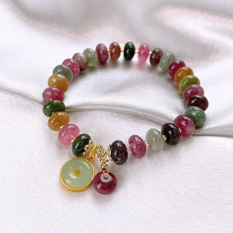 Colourful tourmaline rabbit pendant on a natural stone abacus bead bracelet.