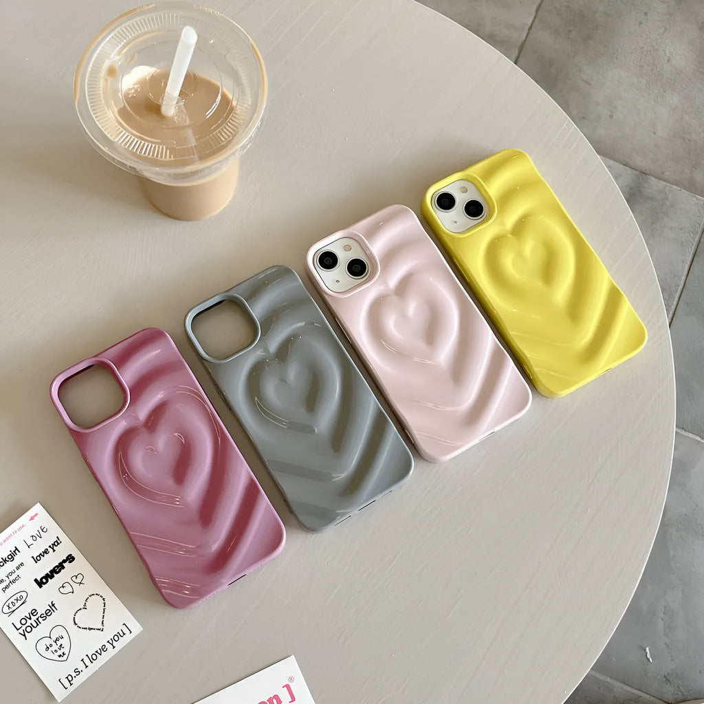 Solid colour iPhone case with a three-dimensional raised heart design on a glass back with TPU bumper.