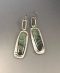 A pair of geometric drop earrings with a white and grey marble pattern on an alloy background.