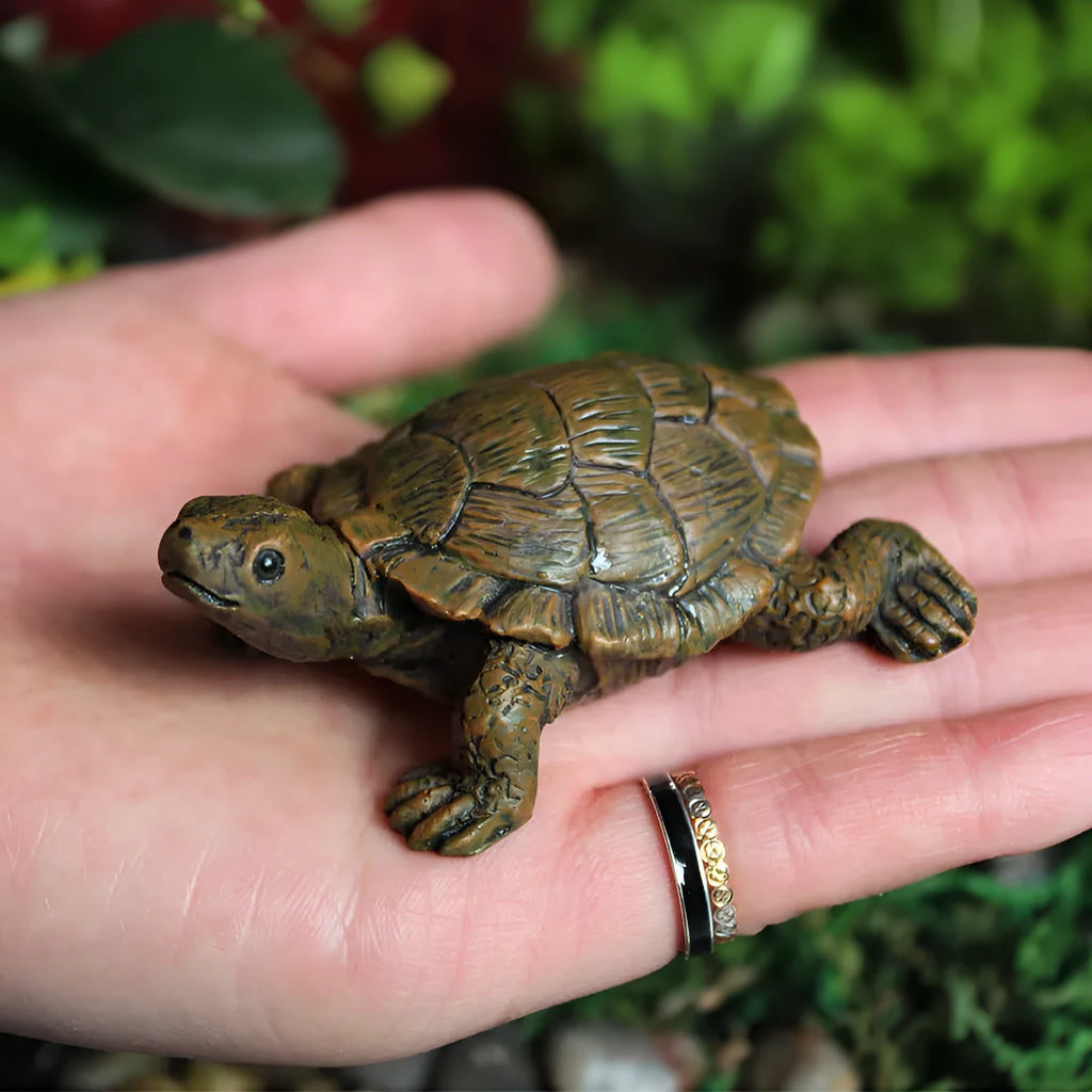 Close-up of a detailed brown resin turtle ornament for miniature garden displays.