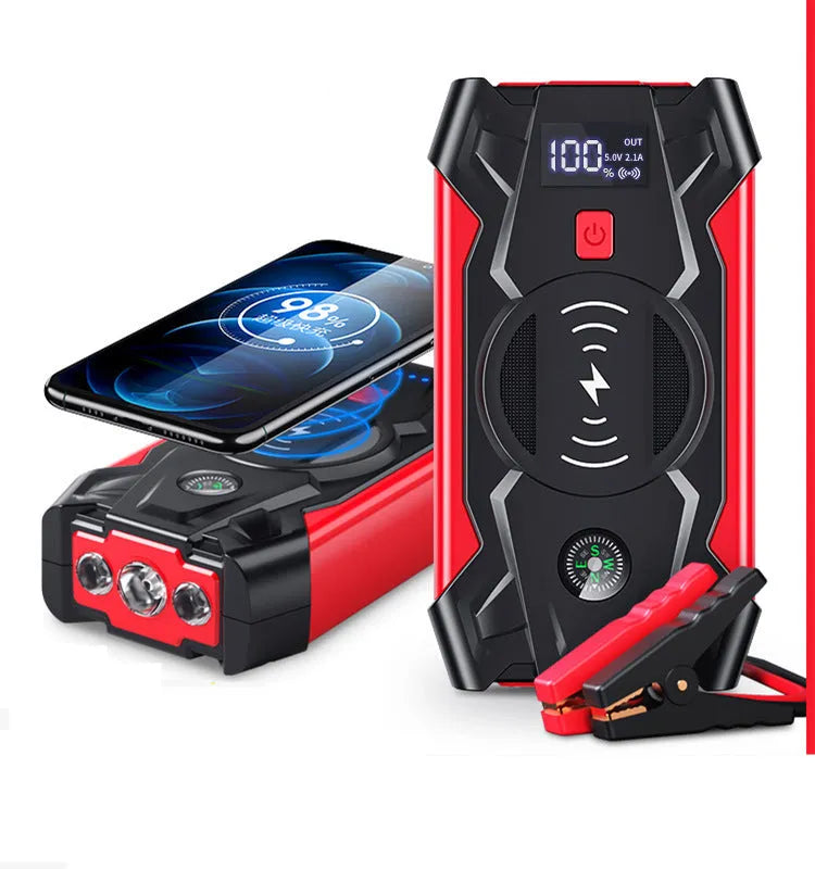 Red car emergency jump starter power pack with digital display and strong jumper clamps.