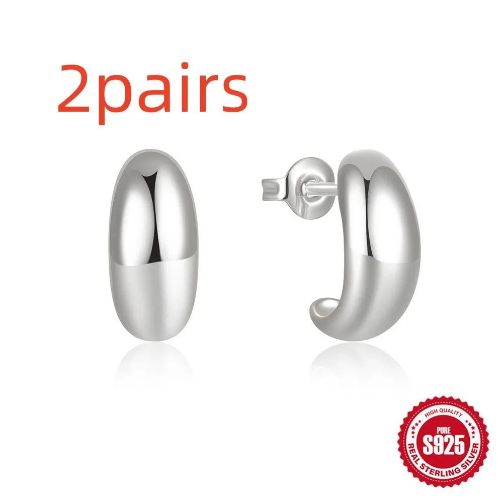 Sterling silver C-shaped stud earrings with glossy electroplated finish