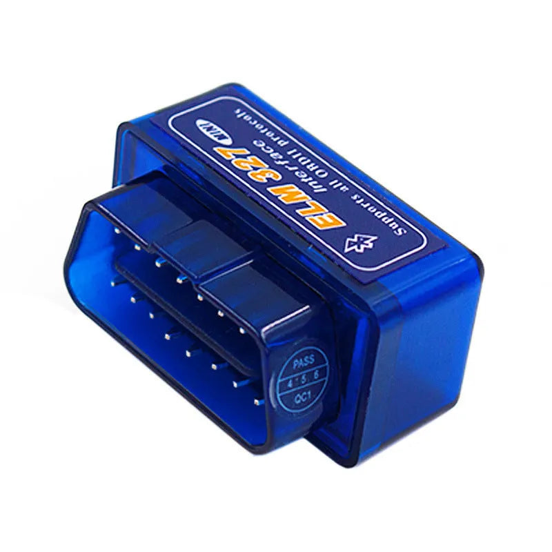 Small black OBD2 Bluetooth scanner car diagnostic code reader next to a vehicle's diagnostic port.