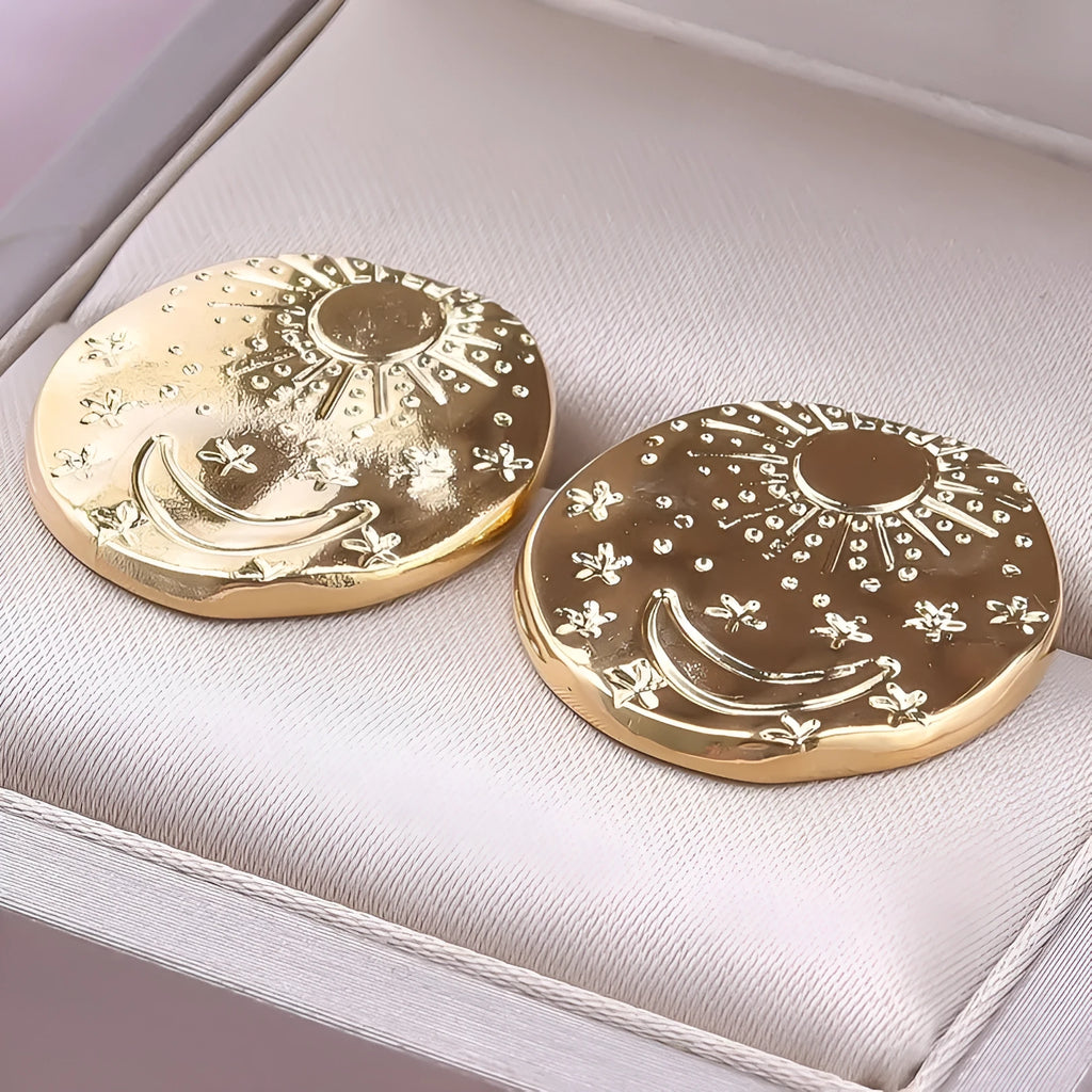 A pair of geometric shell design stud earrings in 304 stainless steel with a gold plated finish.