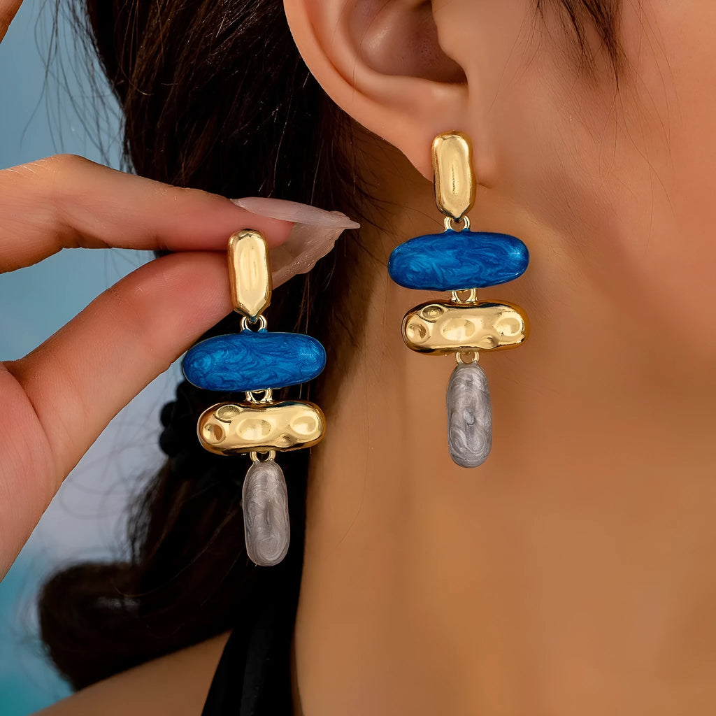 A pair of women's geometric stud earrings with a multicolour electroplated finish on zinc alloy.