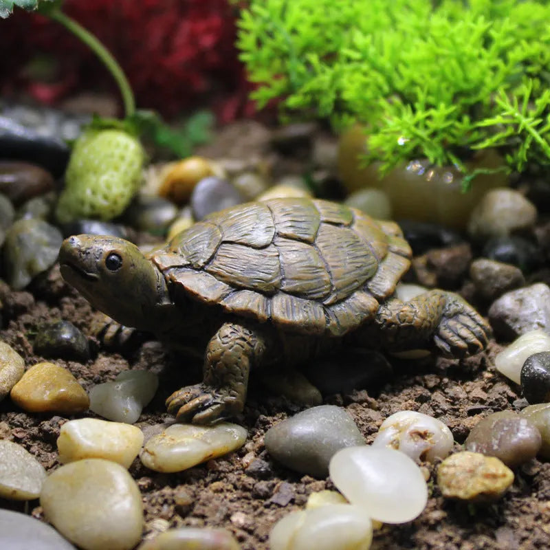 Close-up of a detailed brown resin turtle ornament for miniature garden displays.