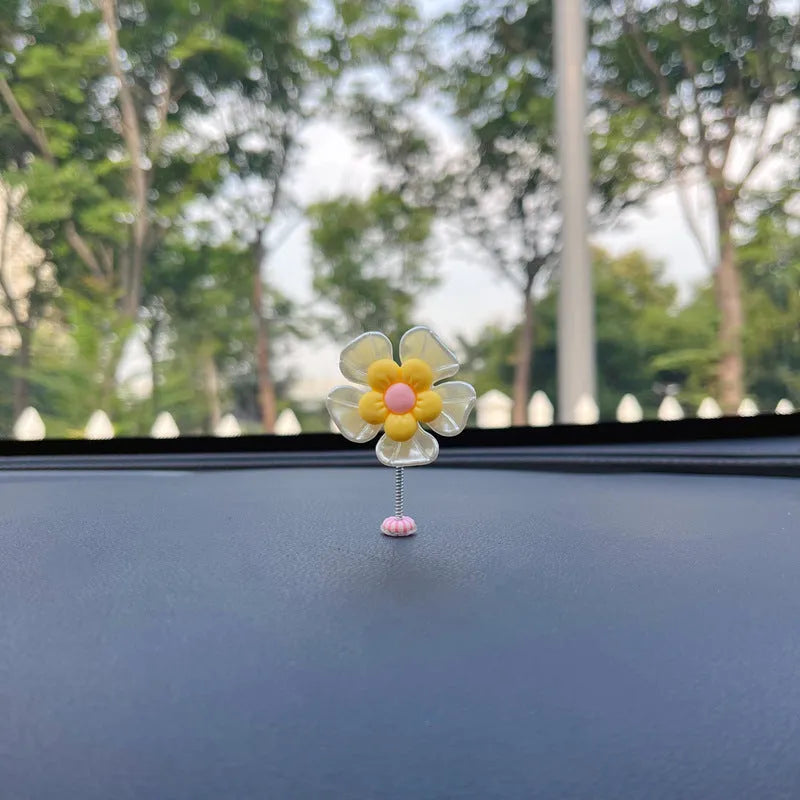 Small blue plastic swing ornament for car rear-view mirror, approx. 5cm tall.