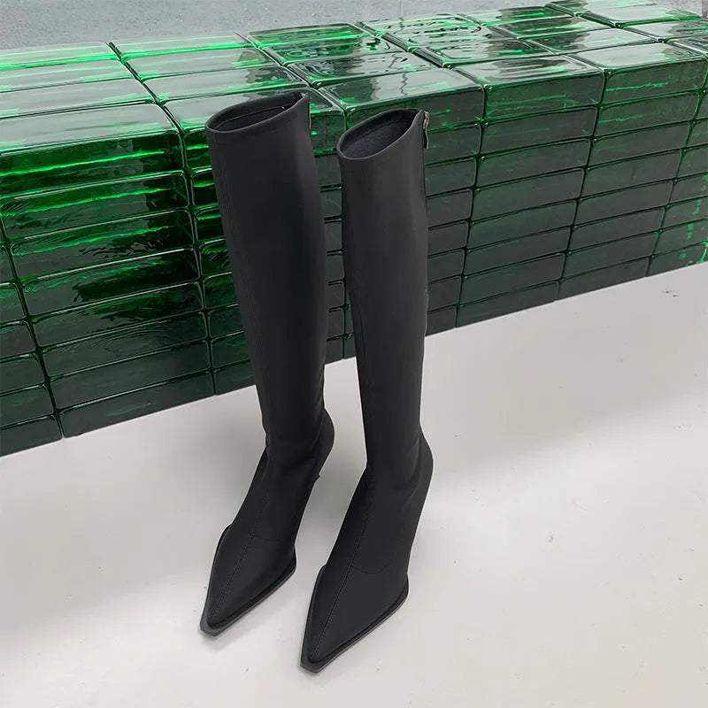 Women's black pointed toe stiletto boots with a back zipper, shown from the side.