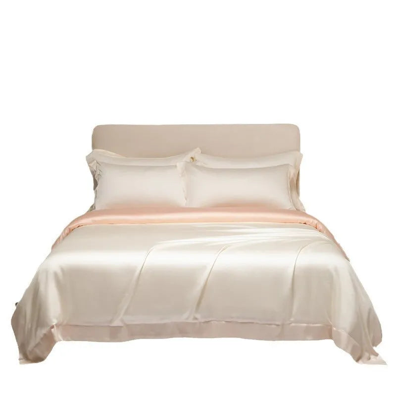 A neatly made bed with a Lenzing Tencel duvet cover and pillowcases in a soft grey colour.
