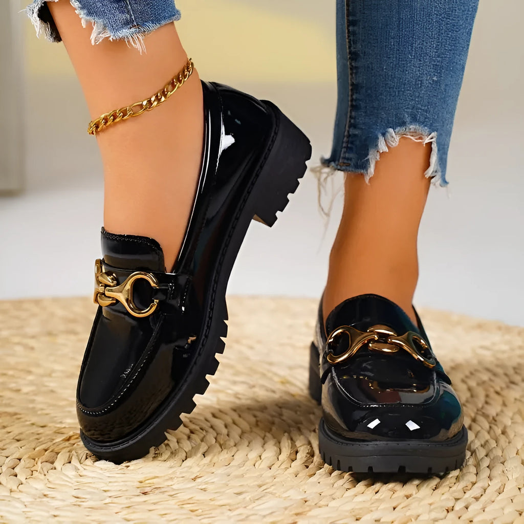 Women's black chunky heel round toe pumps with thick rubber sole and metal decoration