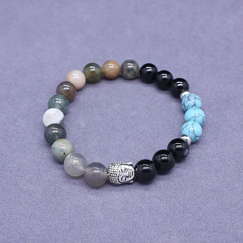 Natural stone elastic bracelet in a mixed colour pattern on a wrist.