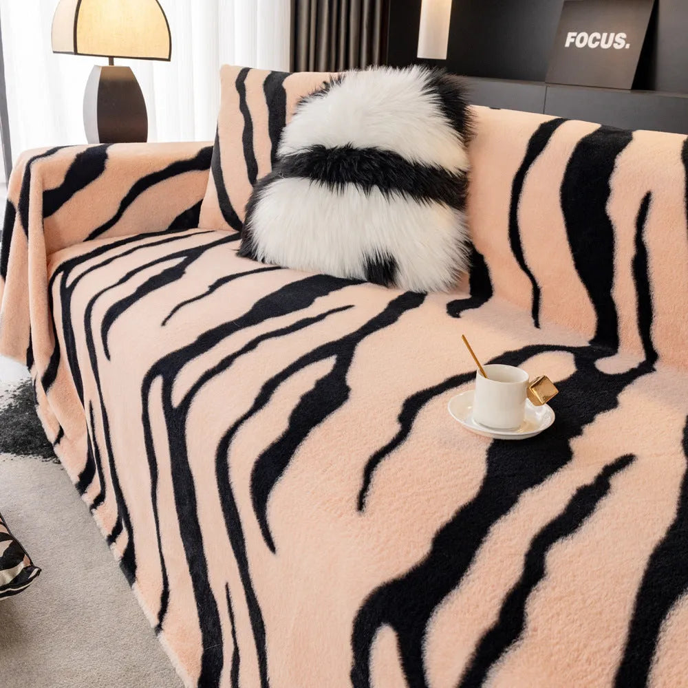 Zebra pattern flannel sofa cover in caramel colour on a sofa, showing non-slip fit and matching pillowcase.