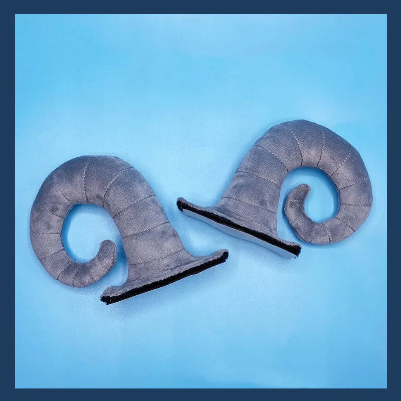 A pair of black demon bull horn ornaments for attaching to a motorcycle helmet.