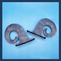 A pair of black demon bull horn ornaments for attaching to a motorcycle helmet.