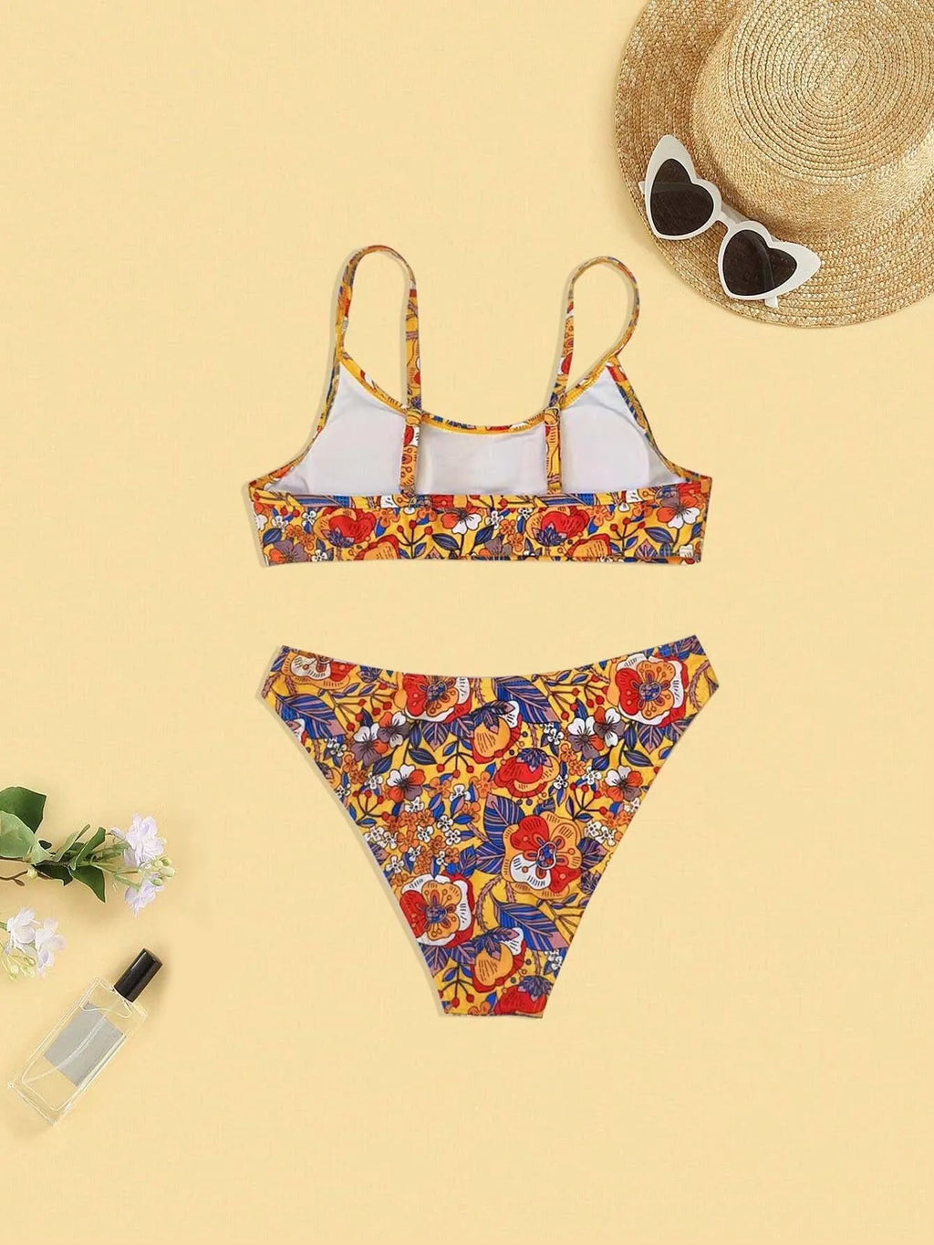 Plus size floral print strap women's bikini swimsuit with briefs style on a hanger.