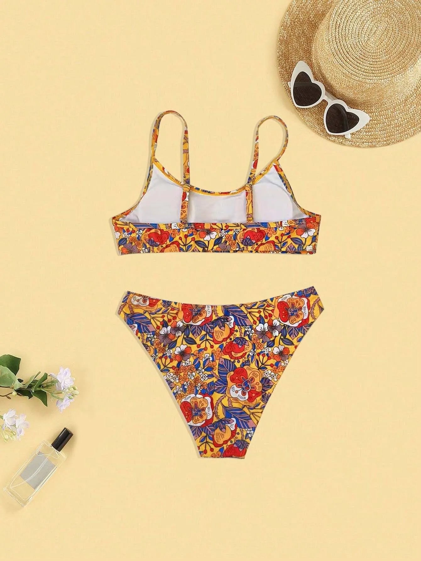 Plus size floral print strap women's bikini swimsuit with briefs style on a hanger.
