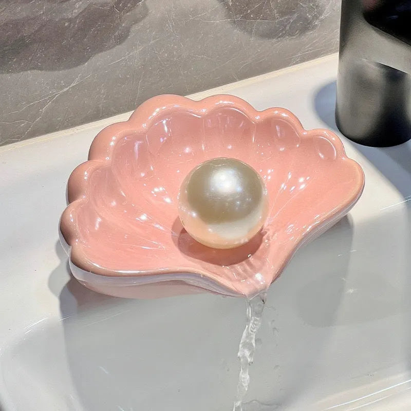 White plastic shell-shaped soap dish for bathroom countertop